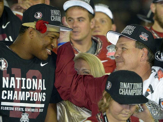 Florida State coach Jimbo Fisher is shown with Jameis Winston after the NCAA BCS National Championship game against Auburn on Jan. 6, 2014, in Pasadena, California. The Seminoles won 34-31.