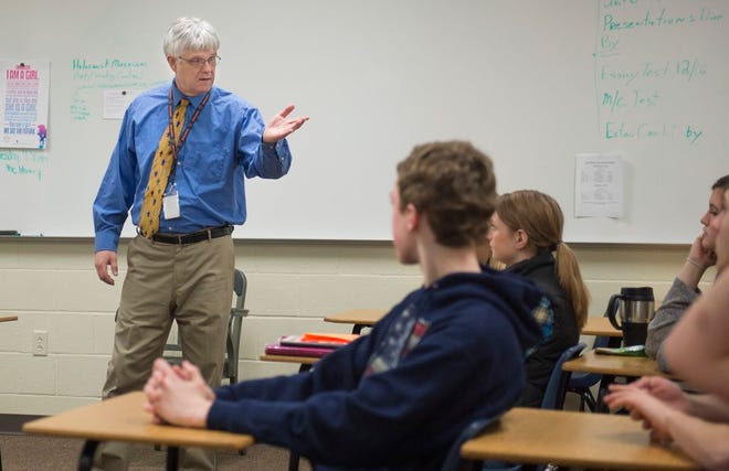 East Peoria High School teacher Marty Green talks in his government class to students who may next year be part of the Junior Achievement program Green oversees.