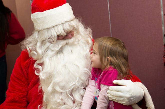 Santa Claus, a close friend of East Stroudsburg University football head coach Denny Douds, visits with Savannah Richterich, 4, of Marshalls Creek, a student from Monroe County Head Start. Santa was a special guest of ESU’s Student-Athlete Advisory Committee as the group held its fifth annual holiday party with the students recently.

Photo provided