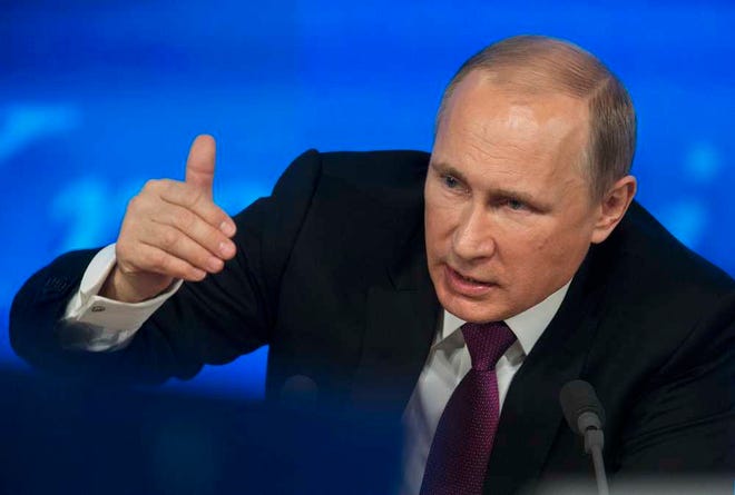 Russian President Vladimir Putin gestures during his annual news conference in Moscow, Russia, Thursday, Dec. 18, 2014. The Russian economy will rebound and the ruble will stabilize, Russian President Vladimir Putin said Thursday at his annual press conference, he also said Putin says Ukraine must remain one political entity, voicing hope that the crisis could be solved through peace talks. (AP Photo/Pavel Golovkin)