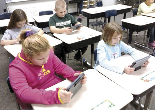 Students in Brandon Wenzel's fourth-grade class at Mendon Elementary benefit from having tablets in their classroom, thanks to funds administered previously through the Mendon Schools Foundation in support of the annual teachers' request list. Funding for the 2014 list is being accepted through Dec. 31. Pictured are Keyara Szymanski and Carlie Doehring, and in the back row, Alexis Ames and Noah Iobe.