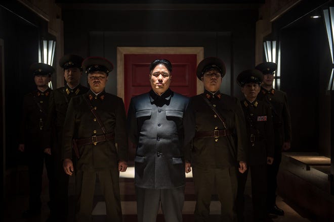 This photo provided by Columbia Pictures - Sony shows, Randall Park, center, as North Korean leader Kim Jong Un in Columbia Pictures' "The Interview." North Korea has been linked to the unprecedented act of cyberwarfare against Sony Pictures that exposed tens of thousands of sensitive documents and escalated to threats of terrorist attacks that ultimately drove the studio to cancel all release plans for "The Interview."