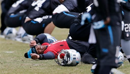 Carolina Panthers quarterback Cam Newton stretches with the team during an NFL football practice in Charlotte, N.C., Thursday, Dec. 18, 2014. (AP Photo/Chuck Burton)