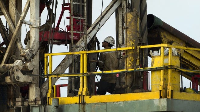 Oil field workers drill for oil at site near Dilley on the Eagle Ford Shale on June 2, 2014.
