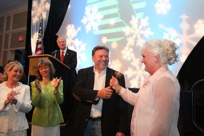 Current Emerald Coast Association of Realtors President Ed Smith passes the gavel to 2015 President Sam Kinkaid during the 2015 ECAR Installation Banquet as Immediate Past President Jan Hooks and Installing Officer Mary Anne Windes look on.