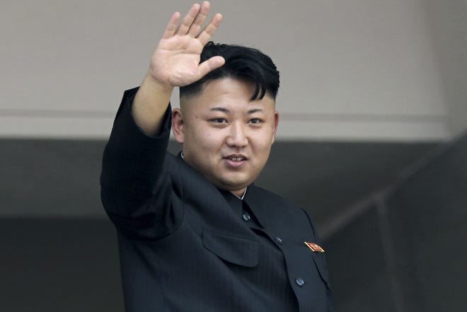 In this July 27, 2013 file photo, North Korea’s leader Kim Jong Un waves to spectators and participants of a mass military parade celebrating the 60th anniversary of the Korean War armistice in Pyongyang, North Korea. The FBI has announced that the isolated country is to blame for the cyber attacks on Sony Pictures.