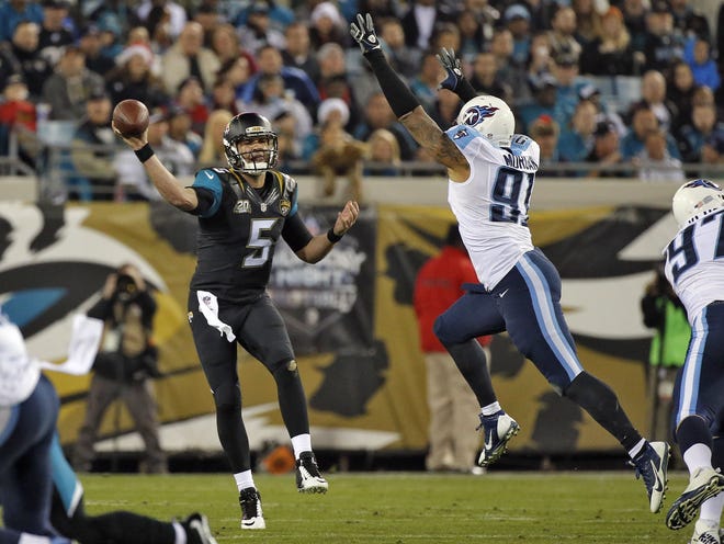 Jacksonville Jaguars quarterback Blake Bortles (5) throws a pass as he is pressured by Tennessee Titans outside linebacker Derrick Morgan (91) during the third quarter Thursday in Jacksonville.