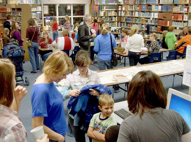 Families mingle in the main library at the first Christmas social and appreciation event held by the Rocky Bayou Christian School Homeschool Assistance Program for all local-area homeschoolers.