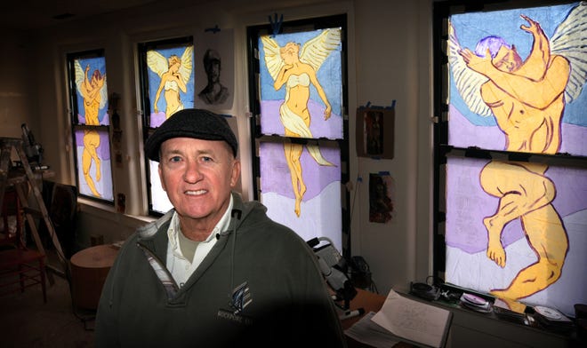 Photos by TOM DORSEY / Salina Journal Salina artist Rick Frisbie has created four angels in the windows of his second story studio in the 100 block of South Santa Fe.