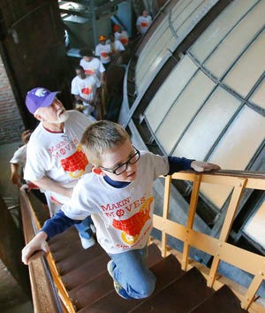 Brady Suchsland, 8, climbs up the stairs that lead to the top of the Statehouse dome during a Makin' Moves workout session. Brady participated in the session with his grandfather, Steve Suchsland, who's been a docent at the Kansas History Museum for 11 years.