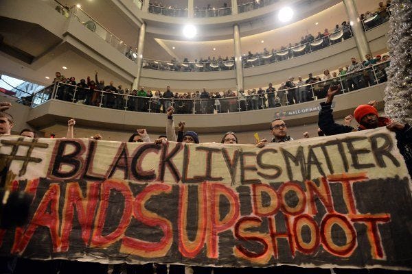 Demonstrators filled the Mall of America rotunda and chanted 'Black lives matter' to protest police brutality Saturday in Bloomington, Minn.
