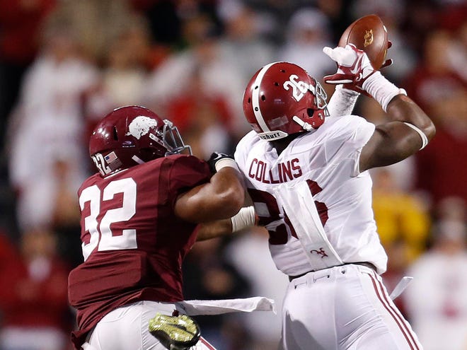 Alabama defensive back Landon Collins intercepts a pass late in the fourth quarter against Arkansas at Donald W. Reynolds Razorback Stadium on Oct. 11 in Fayetteville, Ark. The interception sealed the Crimson Tide's 14-13 victory.