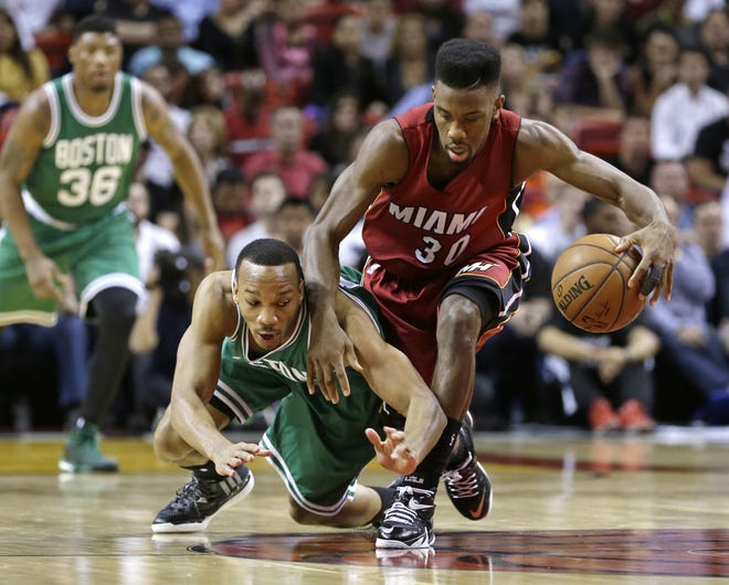 Heat guard Norris Cole (right) beats Celtics guard Avery Bradley too a loose ball during Miami's 100-84 win on Sunday night.