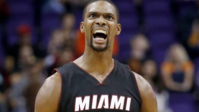 Miami Heat's Chris Bosh celebrates after hitting a 3-pointer against the Phoenix Suns during the second half of an NBA basketball game Tuesday, Dec. 9, 2014, in Phoenix. The Heat won 103-97. (AP Photo/Ross D. Franklin)