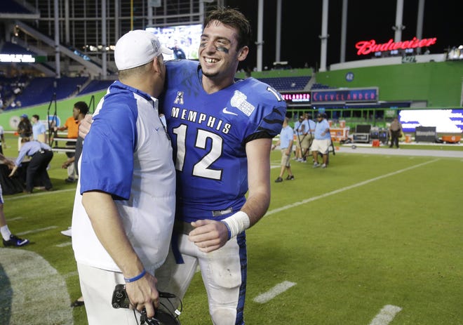 Memphis coach Justin Fuente, left, congratulates quarterback Paxton Lynch after winning Monday's Miami Beach Bowl against BYU. The former Trinity Christian quarterback accounted for seven touchdowns, tying him for the most scores accounted for by a player, according to ESPN.