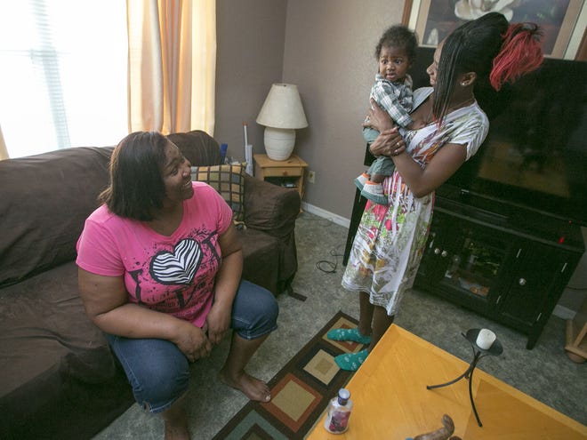 Shirlee Gandy, left, talks with Jasmine Milton and Curlee Brown VI at Gandy's Ocala home on Monday.
