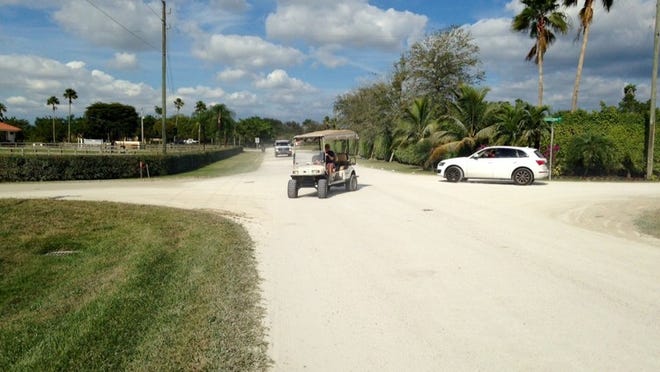 Residents in Wellington’s equestrian community often use golf carts, miniature dirt bikes and other low-speed, all-terrain vehicles to get around, but the village struggles with how strictly to enforce traffic laws that regulate the use of these vehicles on roads and trails. (Kristen M. Clark / The Palm Beach Post)