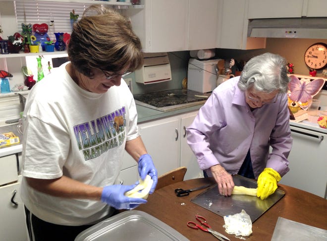 Ruth Rollins, right, walks Brenda Clary, left, through the process of creating homemade mints.