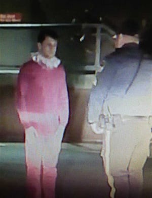 In this image taken from video and provided by the Riverdale, N.J. Police Department, Brian Chellis, 23, of Cedar Grove, N.J. talks with a Riverdale police officer after being found passed out in a car early Dec. 20, 2014. Police say that they found the man, who dressed as an elf, asleep behind the wheel of a van with its engine running, lights on and music blaring. Chellis, who faces drunk driving charges, was issued a summons and released to a family member. (AP Photo/Riverdale Police Department)