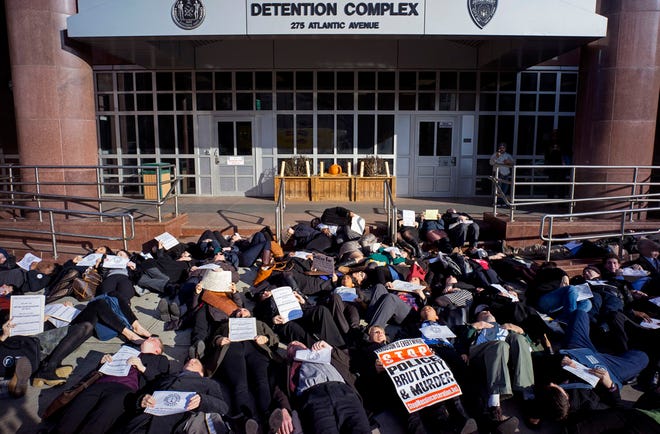 Public defenders, members of the legal community and others lay down during a "die-in" protest in the Brooklyn borough of New York Wednesday, Dec. 17, 2014.