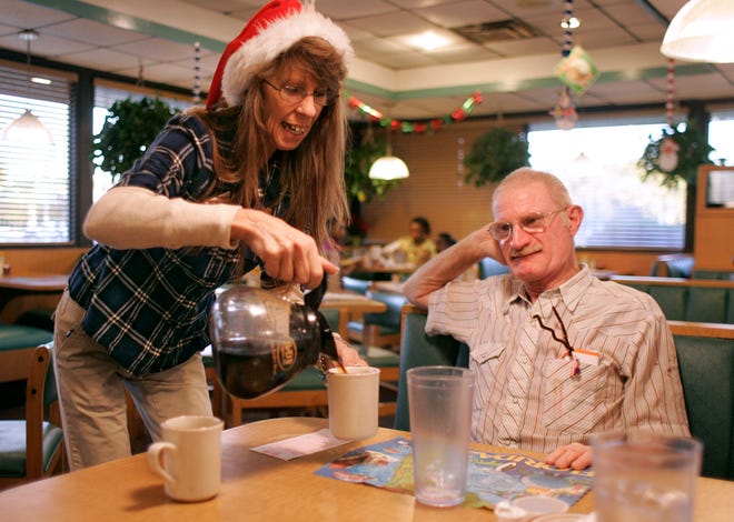In this 2009 file photo, Patricia "Patty" Edgar, left, who is working on Christmas Day, serves coffee to longtime customer Albert "Red" Gregory, right, at The Clock Family Restaurant on Tuesday, December 22, 2009. The restaurant, located at 2010 N. Main St., will have a special menu on Christmas Day 2014 that includes turkey, ham and dressing, and sides.