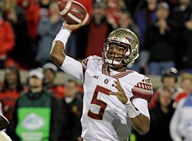 FILE - In this Oct. 30, 2014, file photo, Florida State quarterback Jameis Winston looks to pass in the first half of an NCAA college football game against Louisville in Louisville, Ky. Winston was cleared of the accusations he faced at a student code of conduct hearing involving an alleged sexual assault two years ago, according to documents obtained by The Associated Press on Sunday, Dec. 21, 2014. (AP Photo/Garry Jones, File)