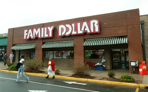 In this Tuesday, Nov. 29, 2005, file photo, customers walk past a Family Dollar store at Hickory Grove Market in Charlotte, N.C. Dollar Tree is buying rival discount store Family Dollar in a cash-and-stock deal valued at about $8.5 billion, the companies announced Monday, July 28, 2014. (AP Photo/Ross Taylor, File)