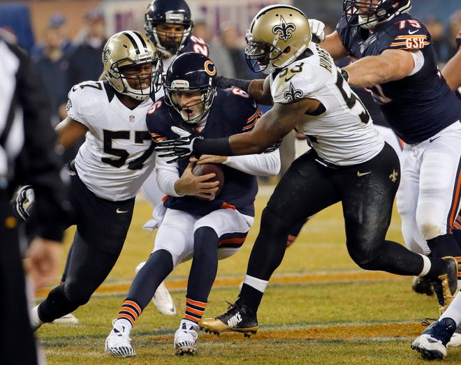 Bears quarterback Jay Cutler, getting a rough ride Dec. 15 from the Saints’ David Hawthorne (57) and Ramon Humber, returns to the starting lineup Sunday at Minnesota after a benching last week. CHARLES REX ARBOGAST/THE ASSOCIATED PRESS