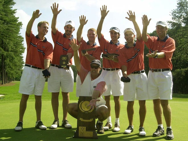 The Florida golf team, with coach Buddy Alexander (bottom), celebrates its NCAA championship Saturday, June 2, 2001. (The Associated Press)