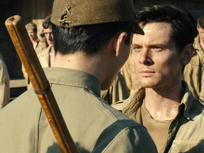 Jack O'Connell portrays Olympian and war hero Louis "Louie" Zamperini in a scene from "Unbroken." (AP Photo/Universal Pictures)