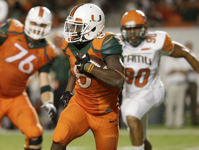 Miami running back Duke Johnson (8) runs for a first down in the first half against Florida A&M on Sept. 6 in Miami Gardens.
