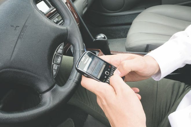 An area man texts safely and within the law, by pulling over and stopping his car before communicating electronically.