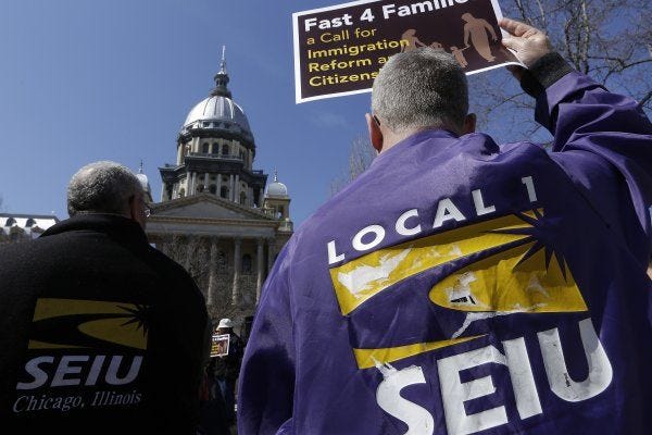 Members of the Service Employees International Union rally March 20 in front of the Illinois State Capitol in support of immigration reform.