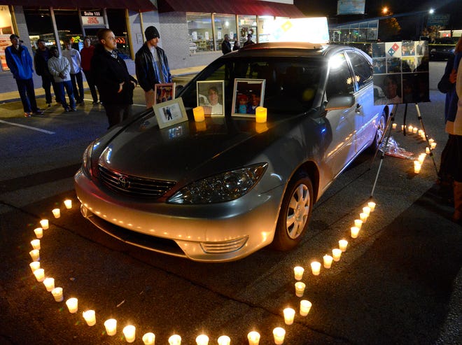 Candles surround slain pizza deliveryman Najeh Masaeid's car during a vigil to remember him in Vestavia Hills, Ala., Thursday, Dec. 25, 2014. Masaeid was killed during a robbery Sunday night. (AP Photo/AL.com, Mark Almon) MAGS OUT