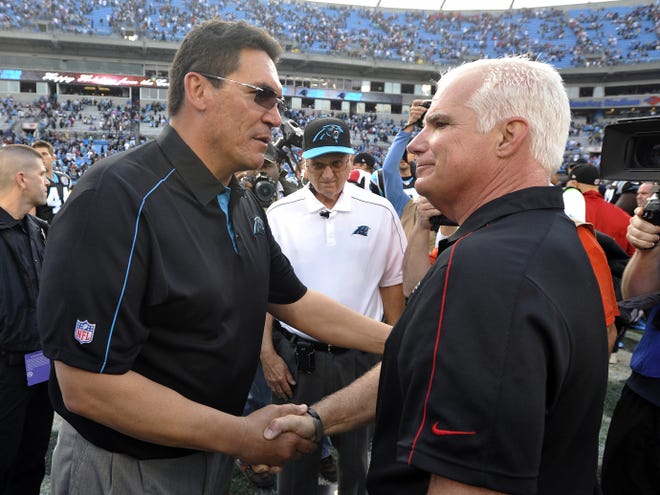 Carolina Panthers head coach Ron Rivera, left, and Atlanta Falcons head coach Mike Smith will square off on Sunday for the NFC South championship.