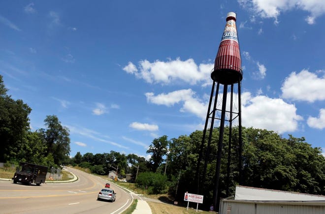 In this July 25, 2014 photo, traffic passes by a 65-year-old, 170-foot water tower in the shape of a ketchup bottle in Collinsville, Ill. The Collinsville water tower is a depiction of Brooks Old Original Rich and Tangy Catsup, which was once produced in the buildings beneath the tower. (AP Photo/Jeff Roberson)