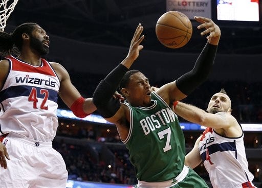 Celtics forward Jared Sullinger (7) is fouled by Washington Wizards forward Nene (42) and center Marcin Gortat (4) in the first half of Saturday's game. AP Photo/Alex Brandon