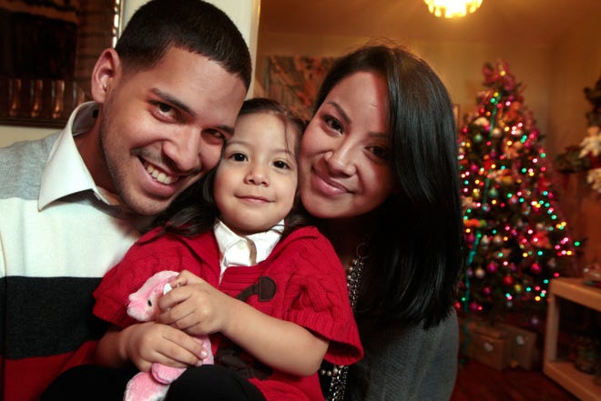 Fernando Ruiz with his wife, Kelyn, and daughter, Mia, in their Cranston home. Ruiz is preparing to graduate from Year Up Providence, a work-force training program.