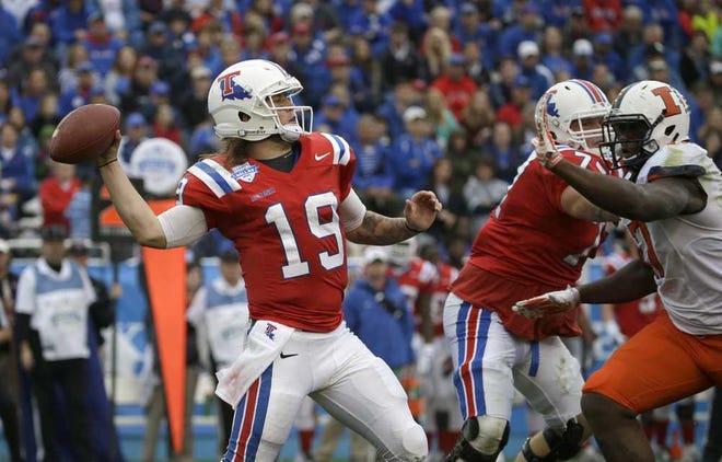 Louisiana Tech quarterback Cody Sokol (19) throws a pass as offensive lineman Mitchell Bell (74) blocks Illinois defensive lineman Jihad Ward (17) during the first half of the Heart of Dallas Bowl NCAA college football game Friday, Dec. 26, 2014, in Dallas. (AP Photo/LM Otero)