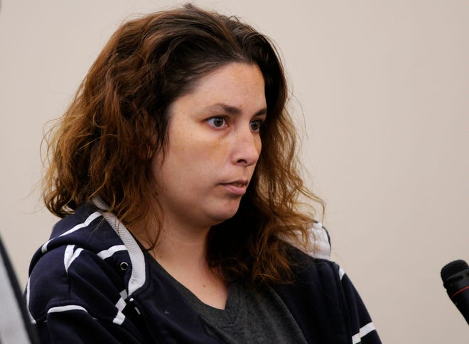 In this Sept. 12, 2014 photograph, Erika Murray of Blackstone listens as she is arraigned at Uxbridge District Court in Uxbridge. Murray, 31, was arrested on charges including fetal death concealment, witness intimidation and permitting substantial injury to a child. Not guilty pleas were entered on her behalf. Detectives investigating a case of reckless endangerment of children found the bodies at the house littered with soiled diapers in Blackstone (T&G Staff/PAUL KAPTEYN)
