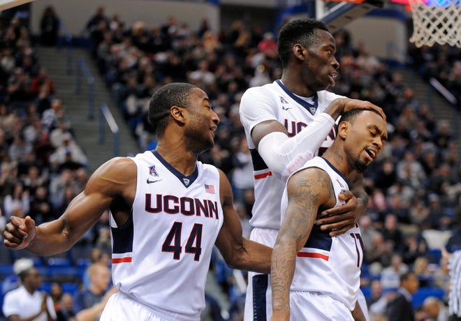 UConn's Rodney Purvis, left, Amida Brimah, center, and Ryan Boatright celebrate Sunday after Boatright scored two of his game-high 18 points during the Huskies' 81-48 win over Central Connecticut State at the XL Center in Hartford. THE ASSOCIATED PRESS