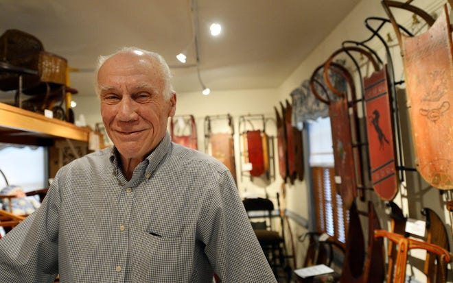 Skip Palmer poses for a portrait among his sleds at his home in Red Lion Wednesday, Dec. 24, 2014. Palmer likes to collect things, and has about 150 sleds. (AP Photo/York Daily Record, Kate Penn)