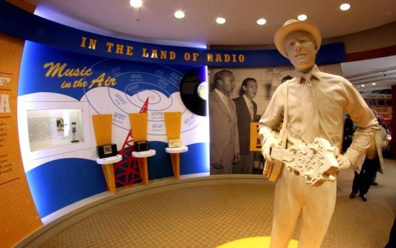 A life-size sculpture of Earl Scruggs greets guests as they enter the Out of Carolina exhibit in the Earl Scruggs Center. (Star file photo)
