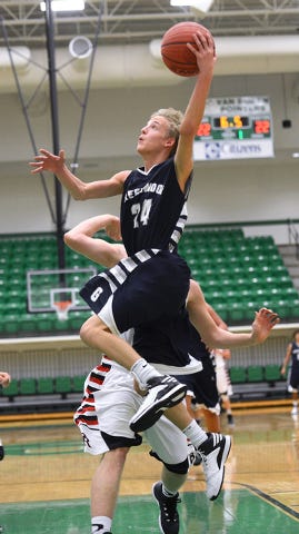 BRIAN D. SANDERFORD • TIMES RECORD / Greenwood’s Matthew Ludwig drives to the basket passed Pea Ridge’s Lance Buttry in the first quarter on Monday, Dec. 1, 2014, during the Citizens Bank Classic at Clair Bates Arena in Van Buren.