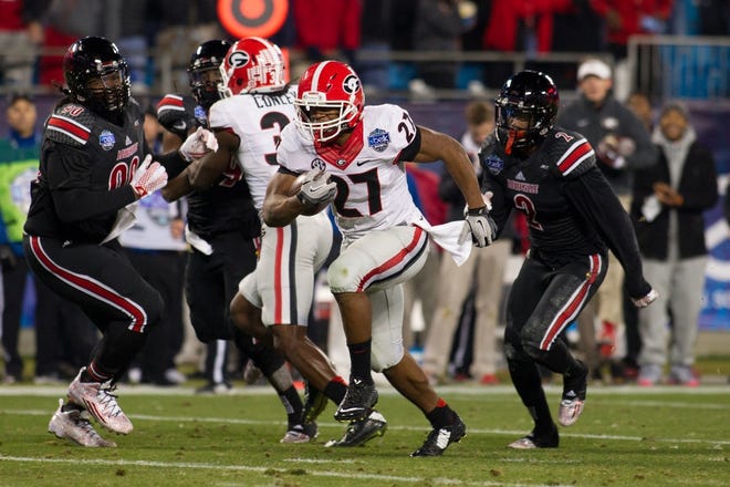 (Photo by Brian Mayhew) Georgia's Nick Chubb breaks off long run in Tuesday's 37-14 Belk Bowl victory over Louisville. Chubb had a bowl-record 266 yards rushing in 33 carries with two touchdowns.