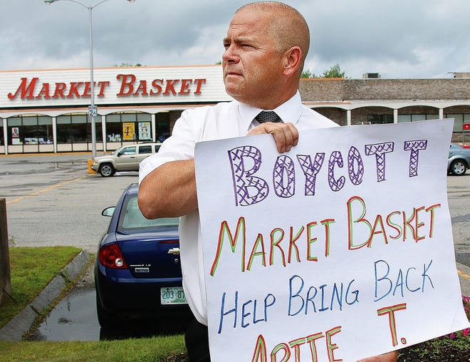Mark Owens, store manager at the Market Basket in Stratham holds a sign in front of store during his break on Monday, July 28, as employees and customers continue to support former ouster CEO Arthur T. Demoulas.

Photo by Rich Beauchesne/Seacoastonline