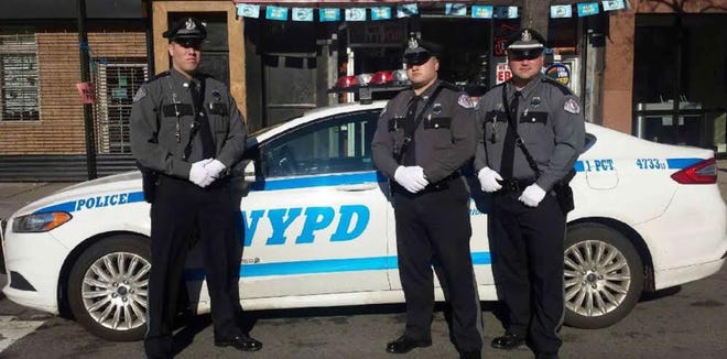 Three Eliot police officers stand in front of a New York Police Department car this weekend after attending the services of NYPD officer Rafael Ramos, who, along with another NYPD officer, was killed by a gunman on Dec. 20. From left to right are officers Isaac Delabruere and Warren Day, and Lt. Elliott Moya.

Courtesy photo