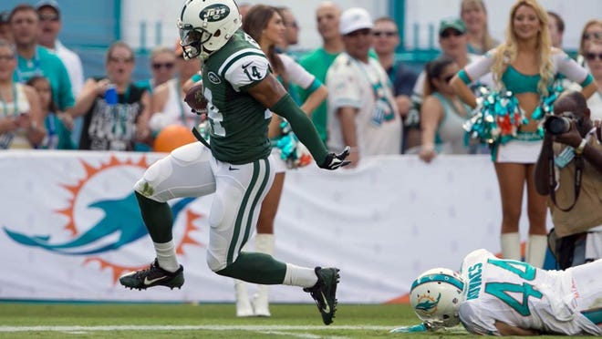 New York Jets receiver Chris Owusu, running a reverse, breaks away from Dolphins defensive back Jordan Kovacs for a 23-yard touchdown in the first quarter Sunday. The Jets amassed 494 yards. (Allen Eyestone / The Palm Beach Post)