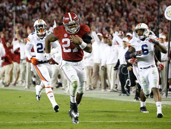 Alabama running back Derrick Henry breaks a fourth-quarter run against Auburn during the Iron Bowl on Nov. 29 in Tuscaloosa. Henry averages 6.9 yards per carry in the second half and 7.4 yards per carry in the fourth quarter this season.