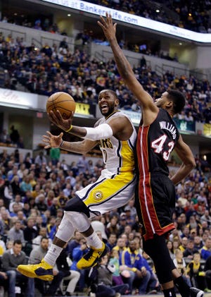 Indiana's C.J. Miles shoots around Miami's Shawne Williams. Miles had 25 points as the Pacers beat the Heat for the sixth consecutive time at home in the regular season.